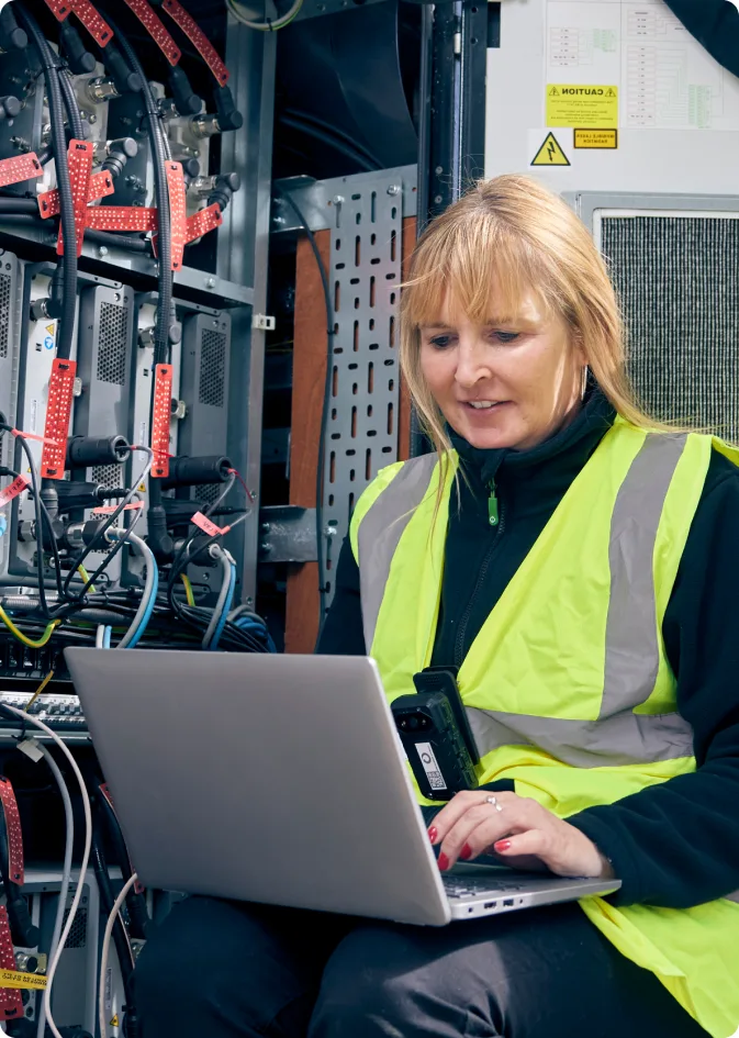 VodafoneThree engineer working on network equipment
