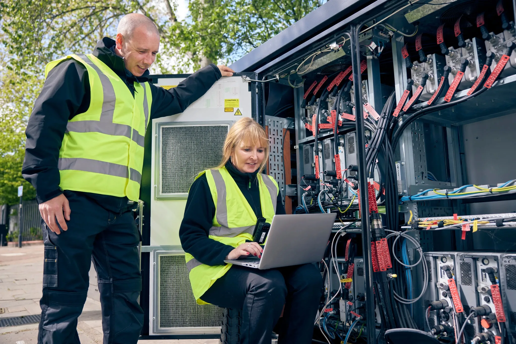 VodafoneThree engineers working on network equipment