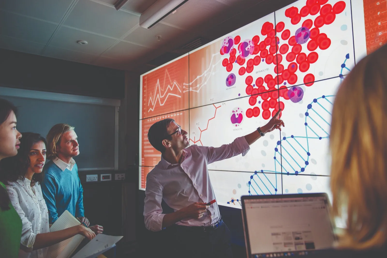 VodafoneThree employee presenting data analysis on a large screen